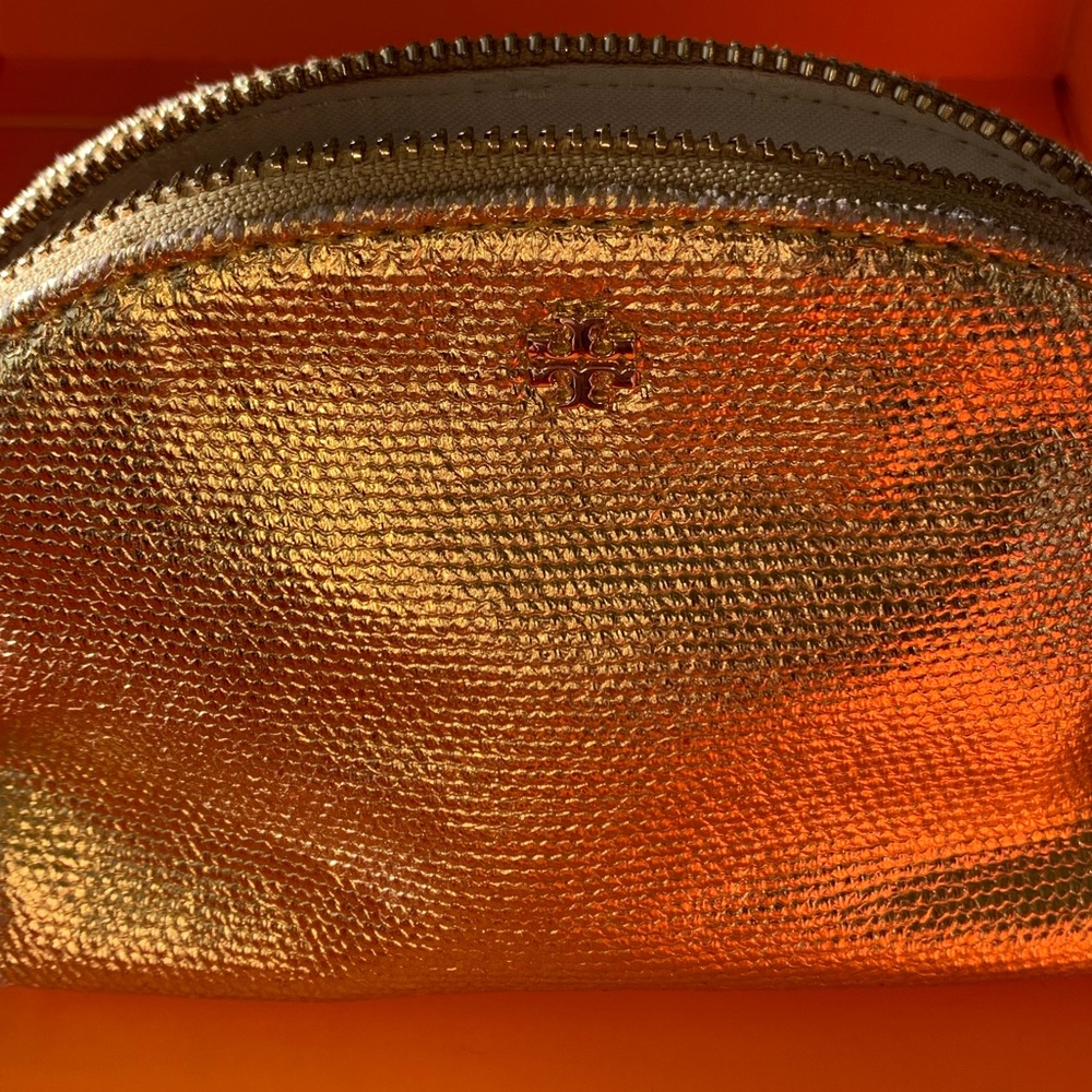 Gold Tory Burch mini bag great for jewelry travel